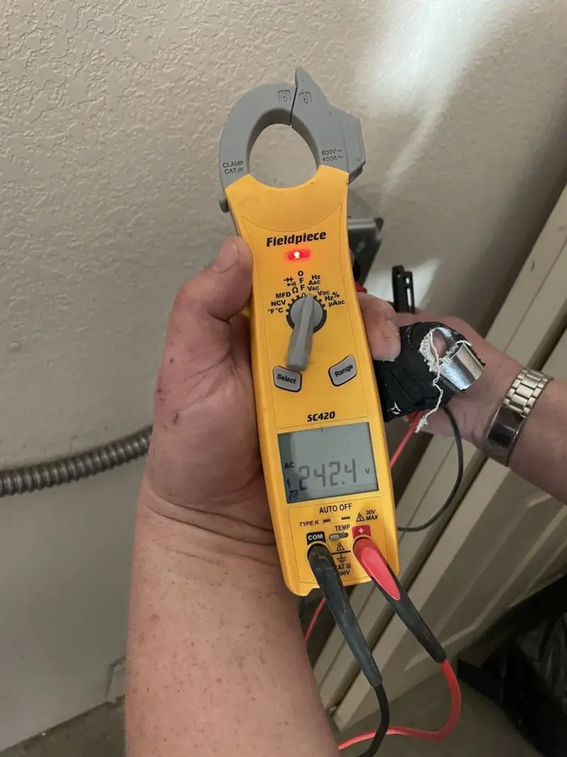 Voltage testing with clamp meter during Outlet Installation in Shelby